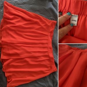 Red pleated, flowy skirt